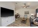 Open living area features plank floors, a ceiling fan, modern furniture and plenty of natural light at 1 Mandarin Ter, Safety Harbor, FL 34695