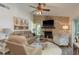 Cozy living room with a beautiful fireplace, ceiling fan, and comfortable seating at 1 Mandarin Ter, Safety Harbor, FL 34695