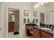 Bathroom with a granite vanity, walk-in shower, and stylish tile flooring at 1 Mandarin Ter, Safety Harbor, FL 34695