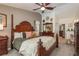 Spacious bedroom with a four-poster bed, ceiling fan, and an ensuite bathroom at 1 Mandarin Ter, Safety Harbor, FL 34695