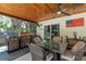 Stainless steel outdoor kitchen and dining area on covered patio with wood ceiling at 1 Mandarin Ter, Safety Harbor, FL 34695