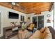 Comfortable outdoor patio with wicker furniture and ceiling fan overlooking a serene backyard at 1 Mandarin Ter, Safety Harbor, FL 34695