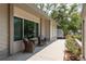Charming side porch featuring comfortable wicker seating, views of the lush landscaping, and a peaceful ambiance at 1 Mandarin Ter, Safety Harbor, FL 34695