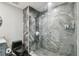 Modern bathroom featuring a glass-enclosed shower with marble tile and a black toilet at 1108 N Franklin St # 502, Tampa, FL 33602
