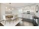 Bright dining room open to the modern kitchen with a stylish chandelier and hardwood flooring at 1108 N Franklin St # 502, Tampa, FL 33602