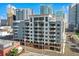 Condo building with balconies and city views against a vibrant blue sky on a busy street with cars passing by at 1108 N Franklin St # 502, Tampa, FL 33602