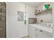 A dedicated laundry room with a washing machine and dryer, plus shelving for storage at 1108 N Franklin St # 502, Tampa, FL 33602