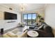 Stylish living room with hardwood floors, balcony, and a decorative stone accent wall at 1108 N Franklin St # 502, Tampa, FL 33602