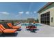 A rooftop deck offering an outdoor dining area, lounge chairs, and city views at 1108 N Franklin St # 502, Tampa, FL 33602