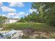 Spacious backyard with grass and trees offering room to enjoy the outdoors at 11187 Blythville Rd, Spring Hill, FL 34608