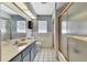 This bathroom features a shower with sliding doors and a vanity with great lighting at 11187 Blythville Rd, Spring Hill, FL 34608