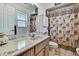 Bathroom featuring a single marble sink vanity, tile floors, and an animal print shower curtain at 11187 Blythville Rd, Spring Hill, FL 34608