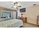 Bright bedroom featuring two twin beds, wooden floors, sliding doors to the lanai, and neutral walls at 11187 Blythville Rd, Spring Hill, FL 34608