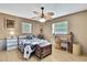 Cozy bedroom featuring hardwood floors, dual windows for ample light and a unique wooden desk at 11187 Blythville Rd, Spring Hill, FL 34608