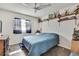 Cozy bedroom featuring a ceiling fan, natural light, and built in shelving at 11187 Blythville Rd, Spring Hill, FL 34608