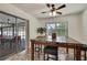 Sunlit dining area featuring sliding glass doors to the lanai, a table, and wicker stools at 11187 Blythville Rd, Spring Hill, FL 34608