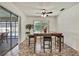 Bright dining area featuring a table with marble top, and a sliding door to the lanai at 11187 Blythville Rd, Spring Hill, FL 34608