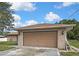 Spacious detached two-car garage with a brown door and brick siding, providing ample parking and storage at 11187 Blythville Rd, Spring Hill, FL 34608