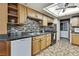 Well-equipped kitchen with wooden cabinets, mosaic backsplash, and black appliances, offering ample storage and workspace at 11187 Blythville Rd, Spring Hill, FL 34608
