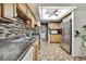 Well-lit kitchen featuring stainless steel appliances, neutral toned cabinets, and mosaic backsplash at 11187 Blythville Rd, Spring Hill, FL 34608