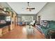 Spacious living room with hardwood floors, large windows, and ample seating, perfect for entertaining guests at 11187 Blythville Rd, Spring Hill, FL 34608