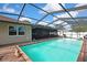 Beautiful pool with screened enclosure and spacious seating area for outdoor enjoyment at 11187 Blythville Rd, Spring Hill, FL 34608