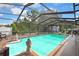 Beautiful pool with screened enclosure and spacious seating area for outdoor enjoyment at 11187 Blythville Rd, Spring Hill, FL 34608