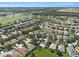 Aerial view of a residential neighborhood and golf course with community pool and lush greenery at 1135 Millbrook Cir, Bradenton, FL 34212