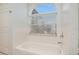 White bathroom featuring a large arched window above the bathtub at 1135 Millbrook Cir, Bradenton, FL 34212