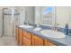 Bright bathroom with a double sink vanity, shower, and large mirror at 1135 Millbrook Cir, Bradenton, FL 34212