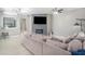 Spacious living room with modern fireplace, mounted TV, and neutral color scheme at 1135 Millbrook Cir, Bradenton, FL 34212