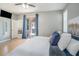 Bright main bedroom with a sliding glass door, ceiling fan, and neutral decor at 1135 Millbrook Cir, Bradenton, FL 34212