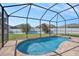 Inviting screened-in pool area surrounded by lush green landscaping and a privacy fence at 1135 Millbrook Cir, Bradenton, FL 34212