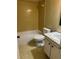 Bathroom with yellow tile and a shower/tub combination at 11485 Oakhurst Rd # 1200-214, Largo, FL 33774