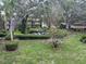 Lush green grounds with mature trees and shrubs creating a serene park-like setting at 11485 Oakhurst Rd # 1200-214, Largo, FL 33774