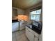 Functional kitchen featuring white appliances, cabinets, and a window with exterior view at 11485 Oakhurst Rd # 1200-214, Largo, FL 33774