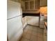 Kitchen features a tile floor, white cabinets, and a matching white refrigerator and stove at 11485 Oakhurst Rd # 1200-214, Largo, FL 33774