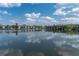 A serene lake view featuring condominiums in the distance under a sky with fluffy clouds at 11485 Oakhurst Rd # 1200-214, Largo, FL 33774