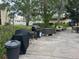 An outdoor patio area with a grill, lush landscaping, and seating at 11485 Oakhurst Rd # 1200-214, Largo, FL 33774