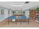 A well-equipped recreation room featuring a ping pong table and a bookshelf for games and reading at 11485 Oakhurst Rd # 1200-214, Largo, FL 33774
