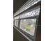 Bright window looking out onto the well-maintained landscaping and gardens at 11485 Oakhurst Rd # 1200-214, Largo, FL 33774