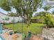 Private backyard with lush lawn, mature trees, shed, and fence, creating a peaceful outdoor retreat at 11762 Barb Ct, Seminole, FL 33778