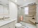 Modern bathroom featuring glass enclosed shower, marble countertop sink and updated fixtures at 11762 Barb Ct, Seminole, FL 33778
