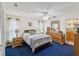 A serene bedroom with blue carpet, an elegant dresser, and a comfortable bed at 11762 Barb Ct, Seminole, FL 33778