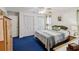 Spacious bedroom with ample closet space and soothing blue carpet at 11762 Barb Ct, Seminole, FL 33778