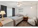 Cozy bedroom with a comfortable bed, chair, and soft natural lighting at 11762 Barb Ct, Seminole, FL 33778