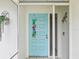 Welcoming front door with decorative accents and a secure screen door at 11762 Barb Ct, Seminole, FL 33778
