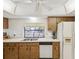 This kitchen includes wooden cabinets, a stainless steel sink, and bright countertops at 11762 Barb Ct, Seminole, FL 33778