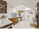 Functional kitchen with white appliances, tile flooring, and ample cabinet space at 11762 Barb Ct, Seminole, FL 33778