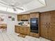 Cozy kitchen features wooden cabinetry, white countertops and tiled floors at 11762 Barb Ct, Seminole, FL 33778